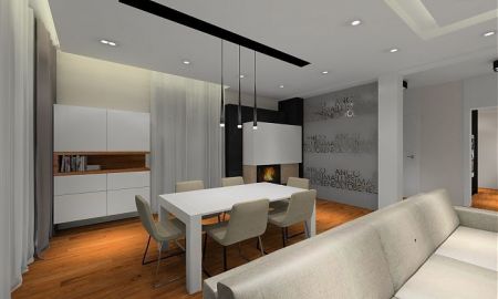 Salon z kominkiem który został obłożony czarnymi płytkami z kwarcytu