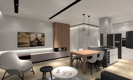 Aranżacja nowoczesnego salonu z aneksem kuchennym.
