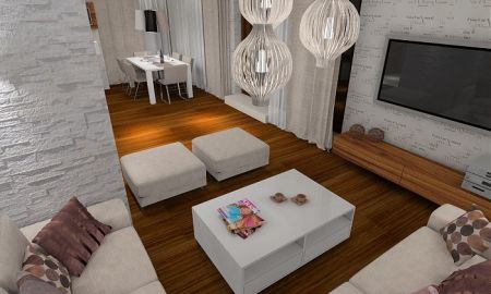 Projekt przytulnego apartamentu z dodatkiem naturalnego kamienia oraz szklaną przesłoną oddzielającą salon od holu. Na filarze dekoracyjny 