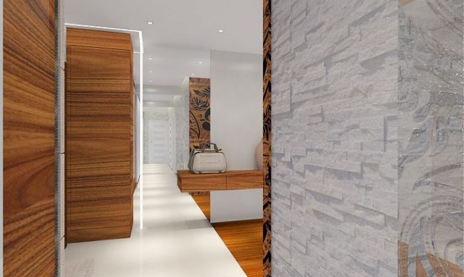 Projekt przytulnego apartamentu z dodatkiem naturalnego kamienia oraz szklaną przesłoną oddzielającą salon od holu. Na filarze dekoracyjny 